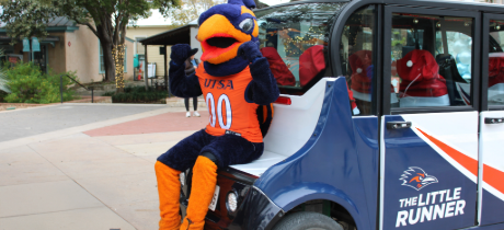 The Rowdy Mascot sits on the back of a Little Runner vehicle.