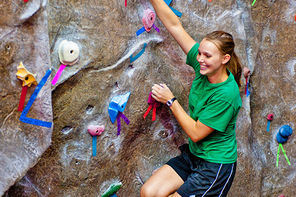 Student climbing rock wall in the UTSA Recreation Center